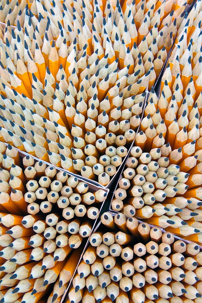 digital Close-up of sharpened wooden pencils organized in a geometric pattern.