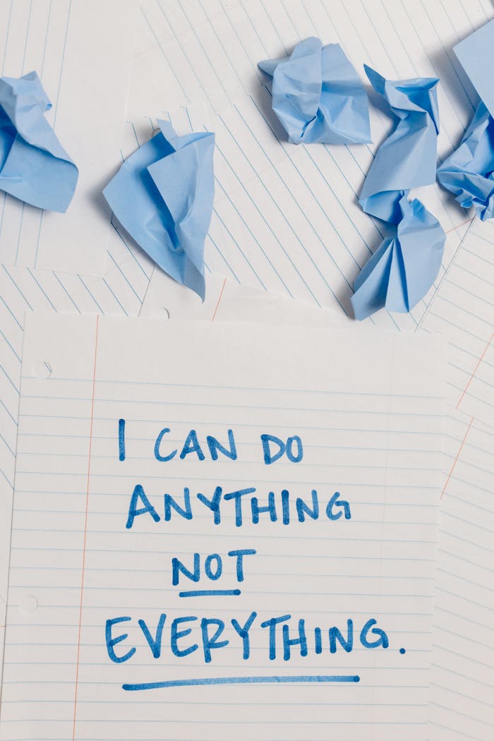 Inspirational message on paper amidst crumpled notes, conveying perseverance.